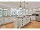 Bright kitchen with white cabinets, granite countertops, and a large center island at 140 Silvermere, Fayetteville, GA 30215