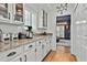 Charming kitchen boasts white cabinetry, granite countertops, and modern appliances at 140 Silvermere, Fayetteville, GA 30215