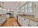 Spacious kitchen with white cabinets, granite countertops, stainless steel appliances, and a large island at 140 Silvermere, Fayetteville, GA 30215