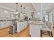 Well-lit kitchen showcasing granite countertops, white cabinets, a large island, and bar seating at 140 Silvermere, Fayetteville, GA 30215