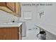 Functional laundry room with built in cabinets, modern machines, and countertops for folding and sorting at 140 Silvermere, Fayetteville, GA 30215