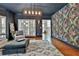 Living room features floral wallpaper, a modern light fixture, and shuttered windows at 140 Silvermere, Fayetteville, GA 30215