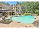 Backyard with a swimming pool, lush greenery, and lounge area, creating an ideal outdoor retreat at 140 Silvermere, Fayetteville, GA 30215