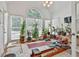 Bright sunroom featuring large windows, a ceiling fan, and space for workout equipment at 140 Silvermere, Fayetteville, GA 30215