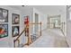 Upstairs hallway with movie posters on the wall and a view of the living spaces below at 140 Silvermere, Fayetteville, GA 30215