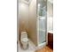 Cozy bathroom with tile floors, neutral walls, toilet, and shower with glass door at 1806 Wynthrop Manor Sw Dr, Marietta, GA 30064