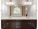 Bathroom vanity area with dual sinks, elegant fixtures, and a large mirror at 1806 Wynthrop Manor Sw Dr, Marietta, GA 30064