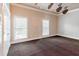 Spacious bedroom with dark carpet, large windows, and neutral walls at 1806 Wynthrop Manor Sw Dr, Marietta, GA 30064