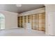 Bright bedroom featuring built-in shelving, decorative molding and large window at 1806 Wynthrop Manor Sw Dr, Marietta, GA 30064