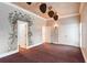 Spacious bedroom with mural wall, dark carpet, and multiple doors at 1806 Wynthrop Manor Sw Dr, Marietta, GA 30064