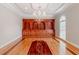 Formal dining room with hardwood floors, custom built-ins, and elegant chandelier at 1806 Wynthrop Manor Sw Dr, Marietta, GA 30064