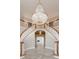 Elegant foyer featuring dual curved staircases and a stunning chandelier at 1806 Wynthrop Manor Sw Dr, Marietta, GA 30064