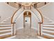 Grand foyer featuring dual staircases, chandelier, and tile flooring at 1806 Wynthrop Manor Sw Dr, Marietta, GA 30064
