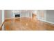 Living room featuring hardwood floors, a fireplace, and access to another room at 1806 Wynthrop Manor Sw Dr, Marietta, GA 30064