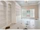 Bright living room features built-in shelving and large windows at 1806 Wynthrop Manor Sw Dr, Marietta, GA 30064