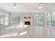 Bright living room with tile floors and fireplace surrounded by large windows and natural light at 1806 Wynthrop Manor Sw Dr, Marietta, GA 30064