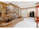 Elegant living room features a beautiful stone water feature and marble flooring at 1806 Wynthrop Manor Sw Dr, Marietta, GA 30064