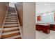 Elegant staircase leading to the kitchen featuring wood and white trim at 1806 Wynthrop Manor Sw Dr, Marietta, GA 30064