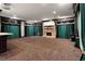 Spacious theater room has emerald and black drapery, stone fireplace, and theater screen at 1806 Wynthrop Manor Sw Dr, Marietta, GA 30064