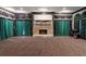Spacious theater room has emerald and black drapery, stone fireplace, and theater screen at 1806 Wynthrop Manor Sw Dr, Marietta, GA 30064
