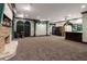 A spacious room with a bar, curtains, and a stone fireplace at 1806 Wynthrop Manor Sw Dr, Marietta, GA 30064