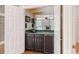 A wet bar with cabinets, a sink, a mini-refrigerator, and a mirrored backsplash at 1806 Wynthrop Manor Sw Dr, Marietta, GA 30064