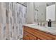 Bathroom with marble vanity, shower-tub combination, and decorative shower curtain at 204 Sawtooth Ct, Canton, GA 30114