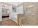 Beautiful bathroom featuring a soaking tub, glass-enclosed shower with bench, and wood-look tile flooring at 204 Sawtooth Ct, Canton, GA 30114
