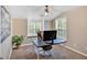 Neutral bedroom with office space features a ceiling fan and natural light from large windows at 204 Sawtooth Ct, Canton, GA 30114
