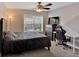 Bedroom with a dark gray bed, gray and white accent wall, and an adjacent desk area at 204 Sawtooth Ct, Canton, GA 30114