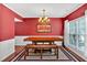 Formal dining room with an elegant chandelier, and bright window at 204 Sawtooth Ct, Canton, GA 30114