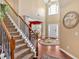 Grand two-story foyer with staircase, hardwood floors, and ample natural light at 204 Sawtooth Ct, Canton, GA 30114