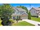 Inviting two-story home with a manicured lawn, cozy porch, and convenient two-car garage at 204 Sawtooth Ct, Canton, GA 30114