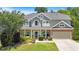 Charming two-story home with covered porch, manicured lawn, and an attached two-car garage at 204 Sawtooth Ct, Canton, GA 30114