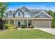 Charming two-story home featuring a well-manicured lawn, inviting porch, and a two-car garage at 204 Sawtooth Ct, Canton, GA 30114