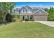 Inviting two-story home with manicured lawn, covered porch, and attached two-car garage at 204 Sawtooth Ct, Canton, GA 30114