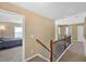 Upstairs hallway with carpet flooring, wood railing, and view to a bedroom at 204 Sawtooth Ct, Canton, GA 30114