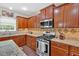 Updated kitchen features granite countertops, stainless steel appliances, and wood cabinets at 204 Sawtooth Ct, Canton, GA 30114