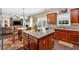 Open kitchen featuring granite counters, island, and adjacent dining and living area at 204 Sawtooth Ct, Canton, GA 30114