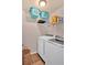 Laundry room with washer, dryer, and overhead shelving to maximize storage space at 204 Sawtooth Ct, Canton, GA 30114