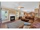 Bright and spacious living room with fireplace, kitchen access, and a plush sectional sofa at 204 Sawtooth Ct, Canton, GA 30114