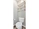 Charming powder room with a classic white toilet and rustic rope shelves for storage and decor at 204 Sawtooth Ct, Canton, GA 30114