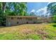 Spacious backyard with grassy lawn and home exterior, offering a great space for outdoor activities and relaxation at 3904 W Hilda Cir, Decatur, GA 30035