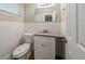 Compact bathroom featuring white tile, a granite countertop, and classic mirror at 3904 W Hilda Cir, Decatur, GA 30035