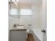 Cozy bathroom with a tub, sink with granite countertops, and a mirror above the sink at 3904 W Hilda Cir, Decatur, GA 30035