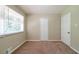 Bright bedroom with neutral walls, plush carpet, and a window offering plenty of natural light at 3904 W Hilda Cir, Decatur, GA 30035