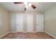 Neutral bedroom featuring carpet, a ceiling fan, and multiple closets at 3904 W Hilda Cir, Decatur, GA 30035