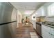 A bright kitchen boasts stainless steel appliances, granite countertops, and modern white cabinetry at 3904 W Hilda Cir, Decatur, GA 30035