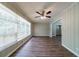 Bright living room featuring hardwood floors, a ceiling fan, and large windows at 3904 W Hilda Cir, Decatur, GA 30035