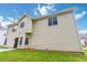 A neutral-colored two-story home with black trim, seen from its well-maintained backyard at 1029 Chaterly Ct, Riverdale, GA 30296